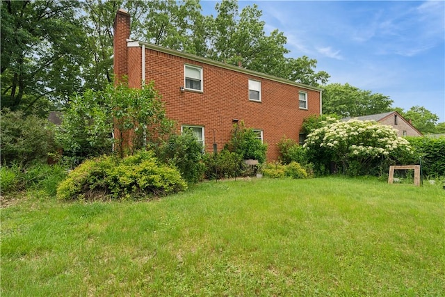 431 Darrell Dr, Penn Hills, PA 15235 - view of side of home featuring a chimney, brick siding, and a yard