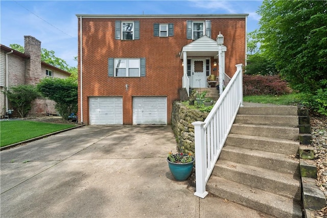 431 Darrell Dr, Penn Hills, PA 15235 - view of front facade featuring an attached garage, brick siding, concrete driveway, and stairs