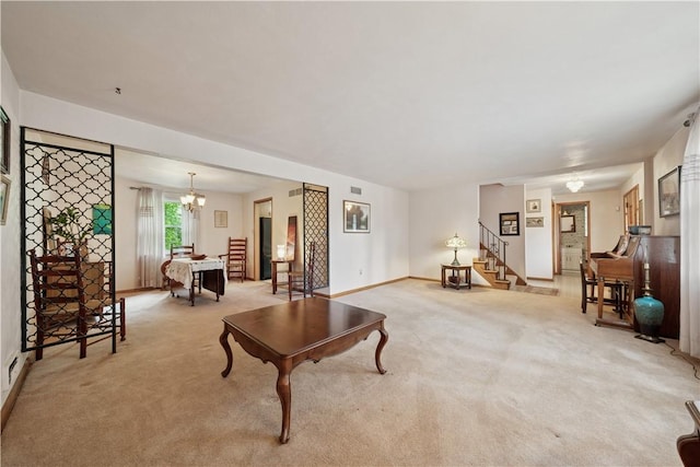 431 Darrell Dr, Penn Hills, PA 15235 - living area with light colored carpet, stairway, baseboards, and a chandelier