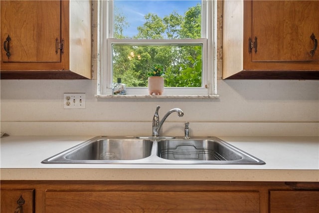 431 Darrell Dr, Penn Hills, PA 15235 - kitchen featuring a sink, brown cabinetry, and light countertops
