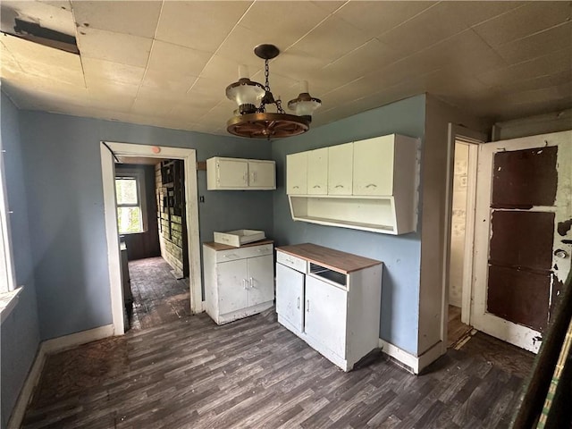 228 Walnut St, Donora, PA 15033 - kitchen featuring dark wood-type flooring, a chandelier, and white cabinetry