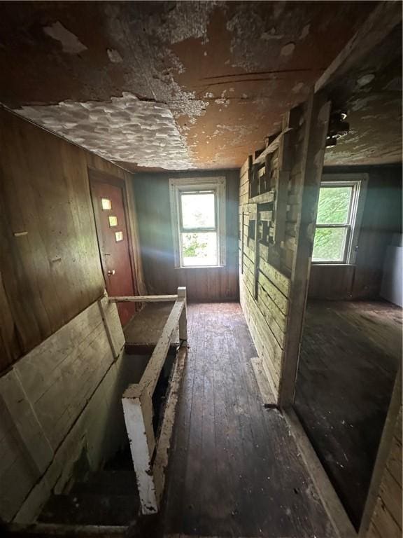 228 Walnut St, Donora, PA 15033 - hall featuring healthy amount of natural light, hardwood / wood-style flooring, wood walls, and an upstairs landing