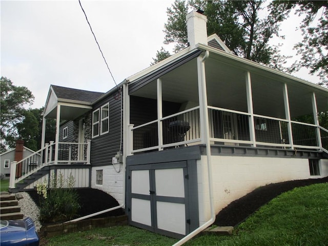 30 Evans Rd, Fallowfield, PA 15022 - view of home's exterior featuring stairway and a chimney