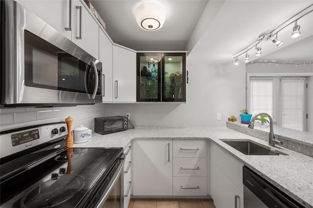 3266 Ward St Unit 8, Oakland, PA 15213 - kitchen with appliances with stainless steel finishes, a sink, white cabinetry, backsplash, and light stone countertops