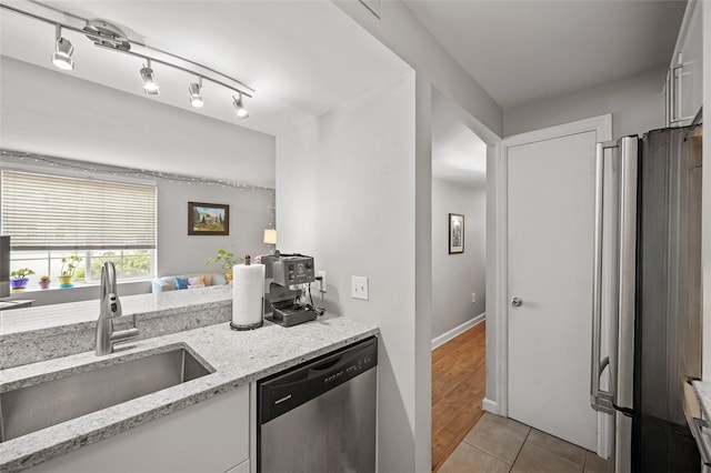 3266 Ward St Unit 8, Oakland, PA 15213 - kitchen with appliances with stainless steel finishes, a sink, white cabinets, light stone countertops, and light tile patterned floors