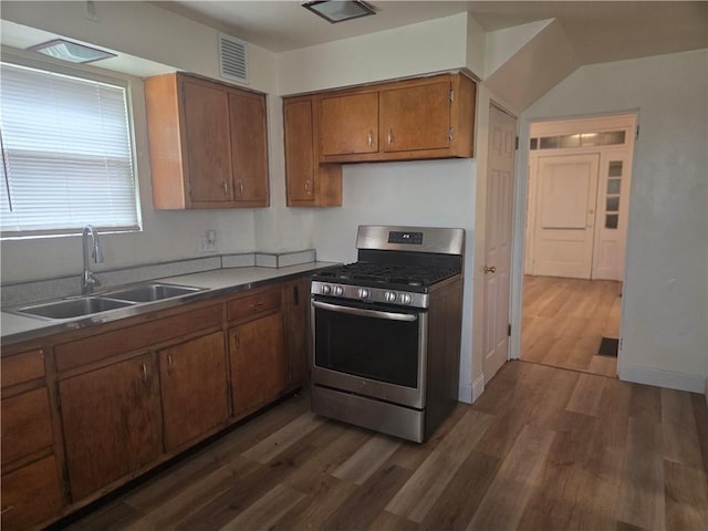 518 Waddell Ave, Clairton, PA 15025 - kitchen with stainless steel range with gas cooktop, a sink, dark wood-style flooring, brown cabinetry, and baseboards