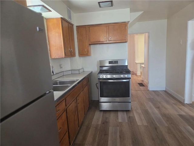 518 Waddell Ave, Clairton, PA 15025 - kitchen featuring stainless steel appliances, brown cabinetry, a sink, dark wood-type flooring, and baseboards