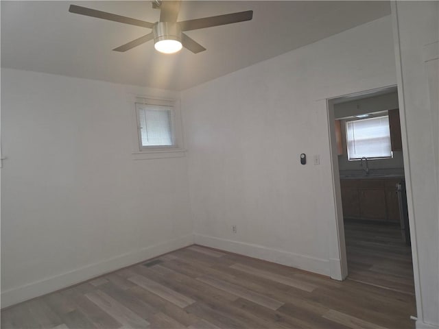 518 Waddell Ave, Clairton, PA 15025 - empty room with wood finished floors, a sink, a ceiling fan, and baseboards