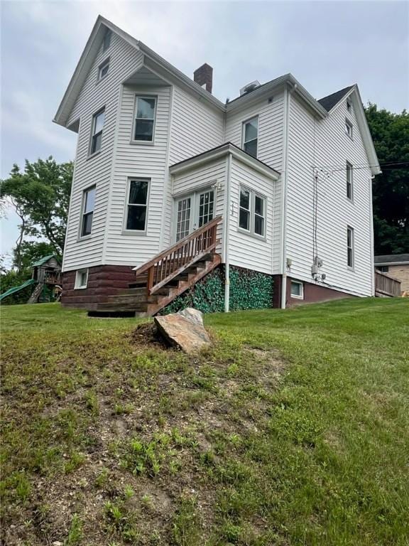 213 Bratchie St, Mars Boro, PA 16046 - back of house with a chimney and a lawn