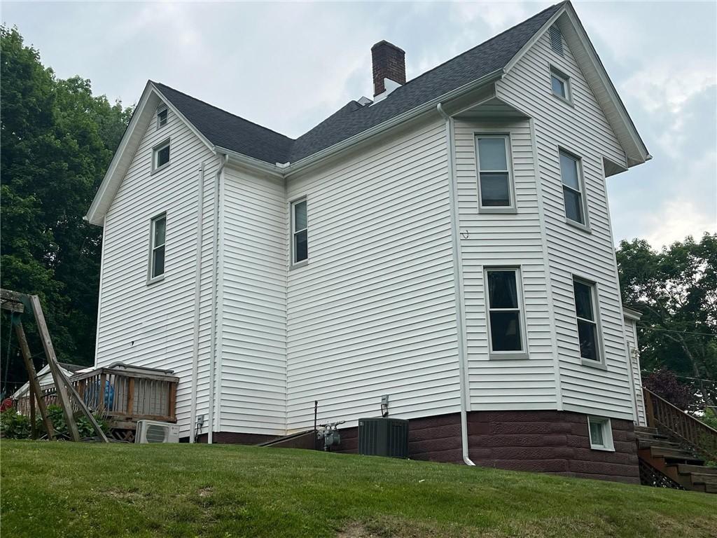 213 Bratchie St, Mars Boro, PA 16046 - view of home's exterior with a chimney, a yard, and central AC