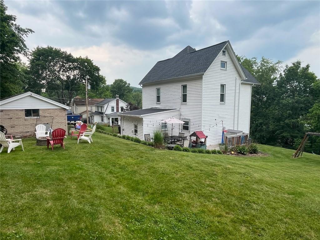 213 Bratchie St, Mars Boro, PA 16046 - back of house featuring a lawn and roof with shingles