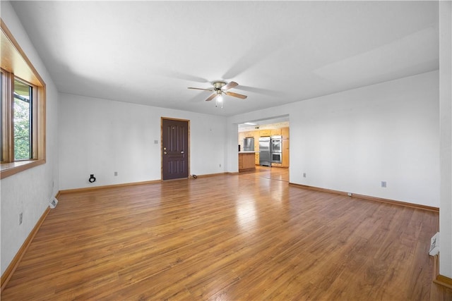 194 Southvue Dr, Whitehall, PA 15236 - unfurnished living room with ceiling fan, light wood-style floors, and baseboards