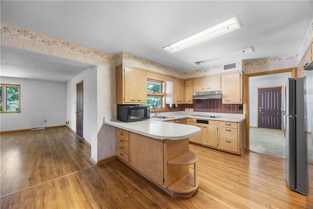 194 Southvue Dr, Whitehall, PA 15236 - kitchen with black appliances, under cabinet range hood, a peninsula, light wood-type flooring, and wallpapered walls