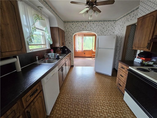 229 Bluff St, Canonsburg, PA 15317 - kitchen with white appliances, wallpapered walls, healthy amount of natural light, dark countertops, and a sink