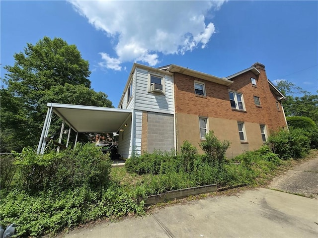 229 Bluff St, Canonsburg, PA 15317 - view of property exterior with a carport, brick siding, and cooling unit
