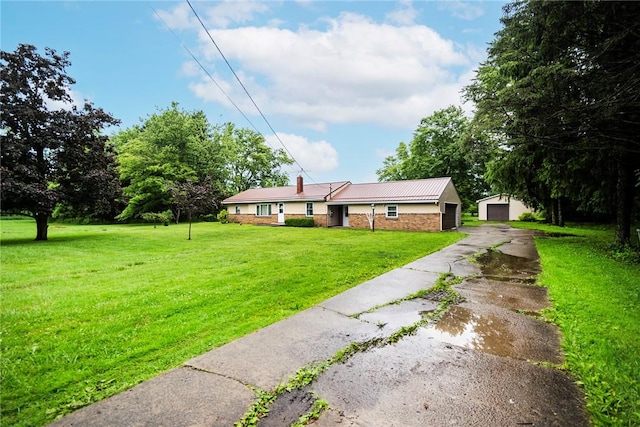 2712 State Route 351, Little Beaver Twp, PA 16120 - single story home featuring a front yard, an outdoor structure, a garage, metal roof, and a chimney
