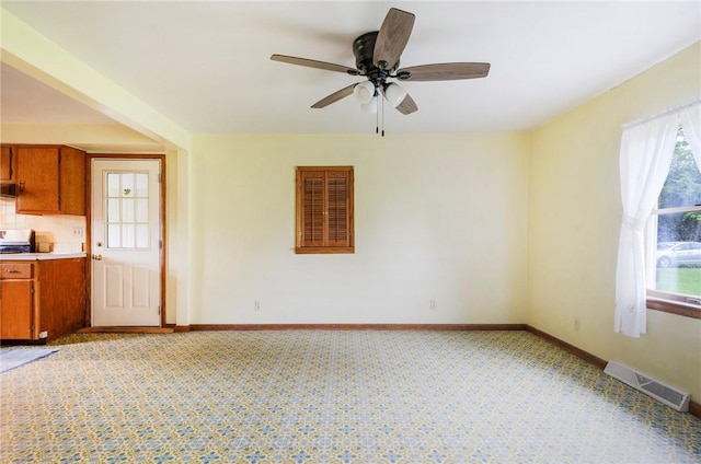 2712 State Route 351, Little Beaver Twp, PA 16120 - kitchen with brown cabinets, a ceiling fan, light carpet, and baseboards