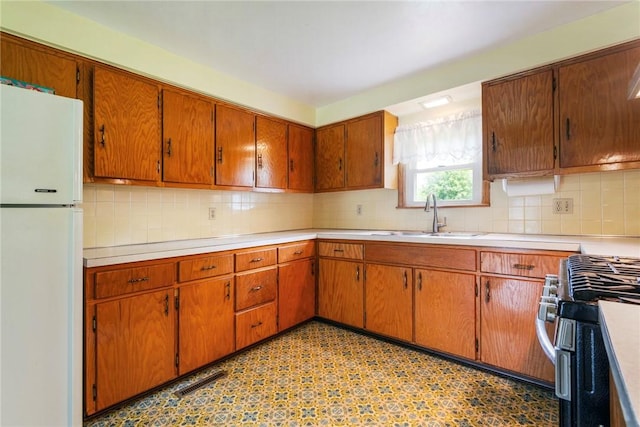 2712 State Route 351, Little Beaver Twp, PA 16120 - kitchen featuring freestanding refrigerator, a sink, stainless steel gas range oven, and light countertops