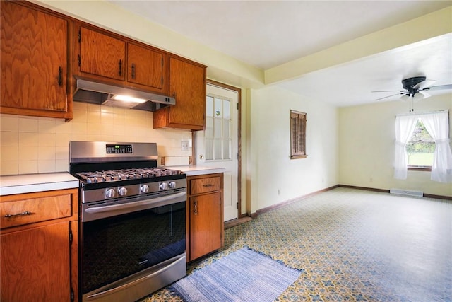 2712 State Route 351, Little Beaver Twp, PA 16120 - kitchen with stainless steel gas range, under cabinet range hood, decorative backsplash, and light countertops