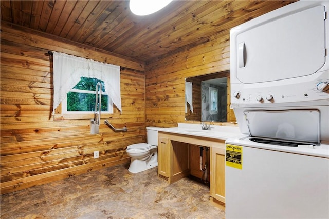 2712 State Route 351, Little Beaver Twp, PA 16120 - bathroom with stacked washer / drying machine, wooden walls, toilet, wood ceiling, and vanity