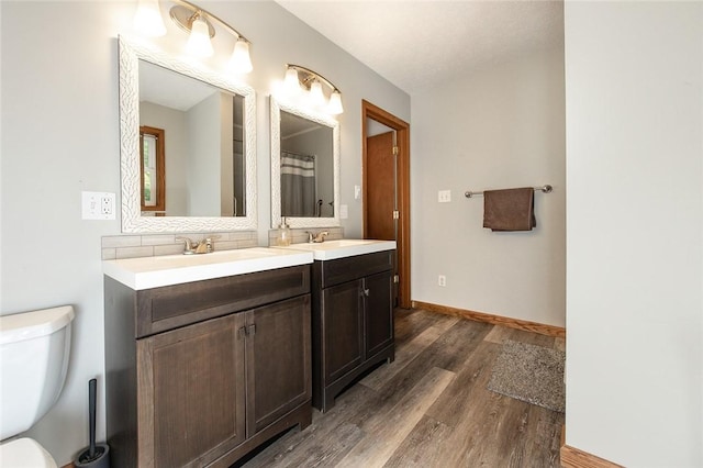 40 Walter Rd, Pine Twp Mer, PA 16127 - full bathroom with toilet, double vanity, wood finished floors, tasteful backsplash, and baseboards