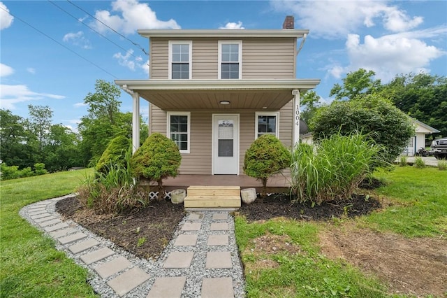 1004 Government Rd, Penn Twp Wml, PA 15642 - view of front of house featuring covered porch, a chimney, and a front lawn