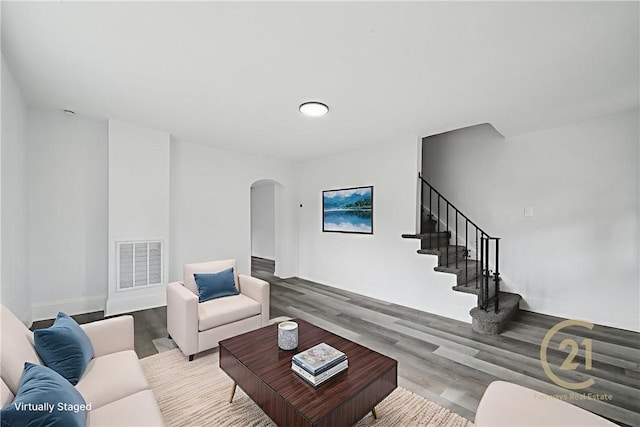 1004 Government Rd, Penn Twp Wml, PA 15642 - living room with arched walkways, wood finished floors, stairway, and baseboards