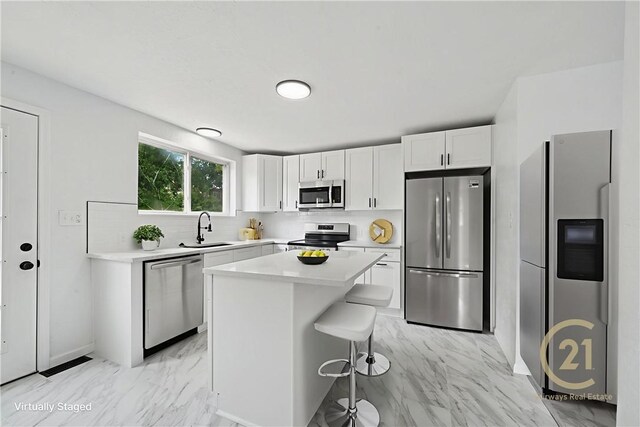 1004 Government Rd, Penn Twp Wml, PA 15642 - kitchen featuring appliances with stainless steel finishes, a sink, light marble finish floors, white cabinets, and light countertops