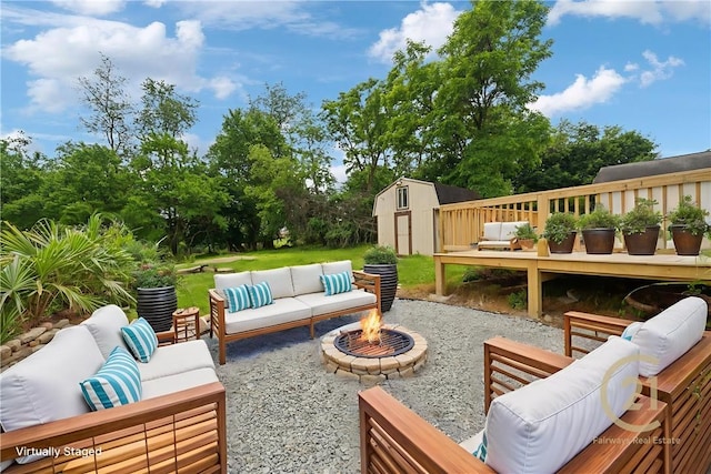 1004 Government Rd, Penn Twp Wml, PA 15642 - view of patio / terrace with an outdoor living space with a fire pit, a deck, and view of wooded area