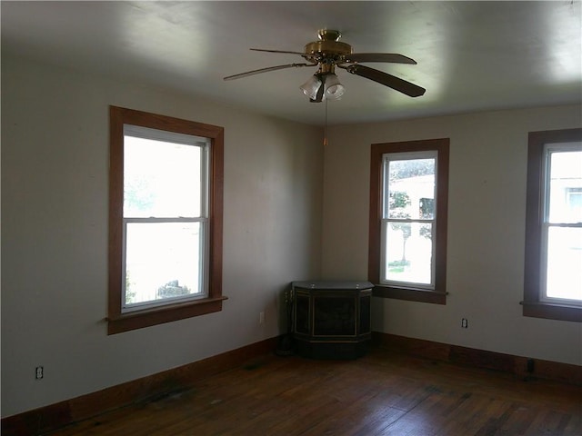 152 E Garrett St, Somerset Twp, PA 15501 - spare room featuring a wood stove, wood finished floors, baseboards, and ceiling fan