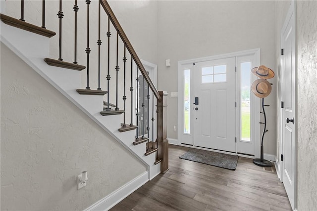 582 Forest Oaks Trl, North Huntingdon, PA 15642 - foyer entrance featuring healthy amount of natural light, wood finished floors, a high ceiling, stairs, and baseboards