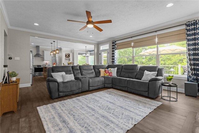 582 Forest Oaks Trl, North Huntingdon, PA 15642 - living room with a ceiling fan, ornamental molding, baseboards, dark wood-style flooring, and a chandelier