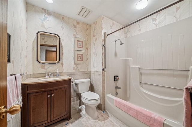 436 Lakewood Rd, Hempfield Twp Wml, PA 15601 - full bath featuring wallpapered walls, toilet,  shower combination, vanity, and tile walls