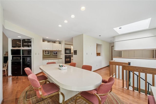 436 Lakewood Rd, Hempfield Twp Wml, PA 15601 - dining room featuring beverage cooler, a skylight, light wood-style floors, and recessed lighting
