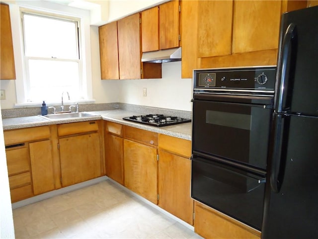 30 Coulter St, Crafton, PA 15205 - kitchen with black appliances, a sink, under cabinet range hood, light countertops, and brown cabinets