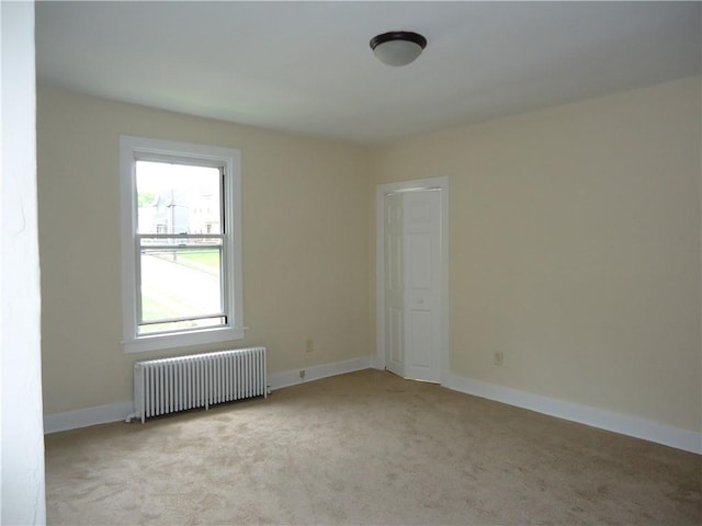 30 Coulter St, Crafton, PA 15205 - empty room with radiator, light colored carpet, and baseboards