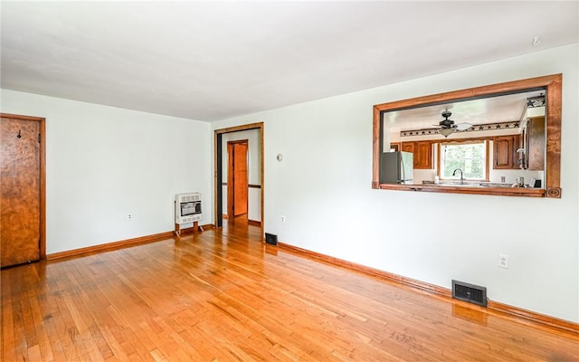 2760 Ridge Road Ext, Economy, PA 15005 - unfurnished room featuring heating unit, light wood-type flooring, baseboards, and a sink