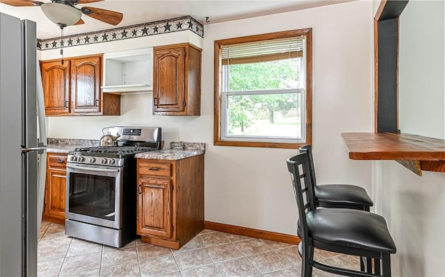 2760 Ridge Road Ext, Economy, PA 15005 - kitchen featuring appliances with stainless steel finishes, a ceiling fan, and brown cabinetry