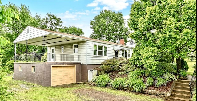 2760 Ridge Road Ext, Economy, PA 15005 - rear view of house with a chimney, driveway, a garage, and a balcony