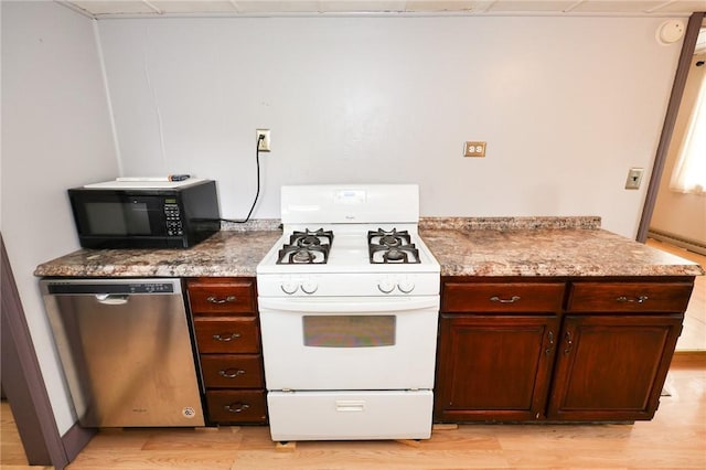409 Summit St, Grove City Boro, PA 16127 - kitchen featuring white gas stove, stainless steel dishwasher, black microwave, light wood finished floors, and light stone countertops