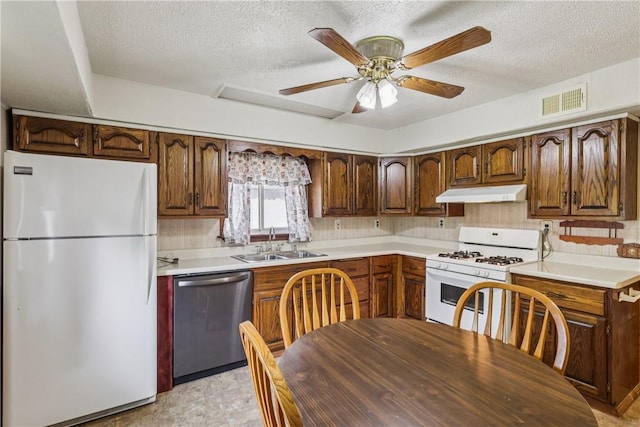 1913 Glen Rd, Pa, PA 15001 - kitchen featuring white appliances, under cabinet range hood, a sink, a textured ceiling, and light countertops