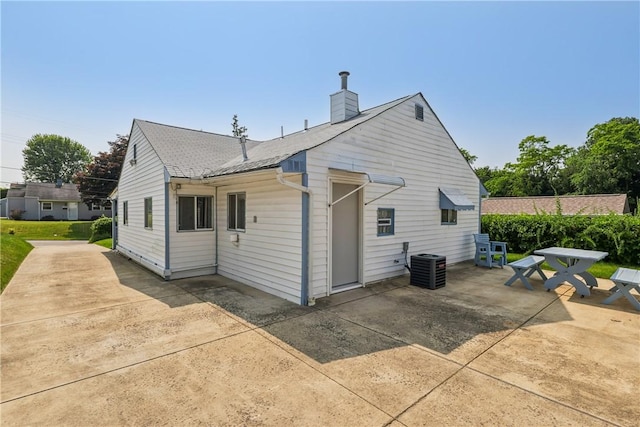 1913 Glen Rd, Pa, PA 15001 - rear view of property with a patio area, a chimney, central AC, and roof with shingles