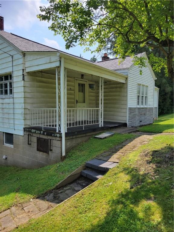 36 Daisytown Rd, Centerville, PA 15427 - bungalow-style home with covered porch, a front lawn, and a chimney