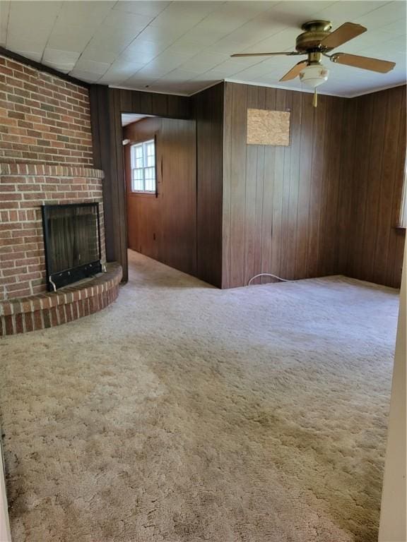 36 Daisytown Rd, Centerville, PA 15427 - unfurnished living room featuring a brick fireplace, ceiling fan, carpet flooring, and wood walls