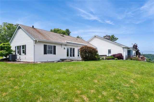 378 Stoneylonesome Rd, Cook Twp, PA 15687 - rear view of house featuring central AC unit, a lawn, french doors, and roof with shingles