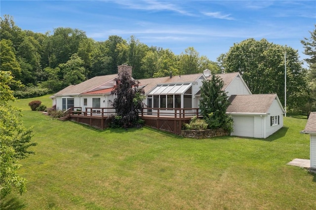 378 Stoneylonesome Rd, Cook Twp, PA 15687 - rear view of house featuring a wooden deck, a lawn, a chimney, and a sunroom