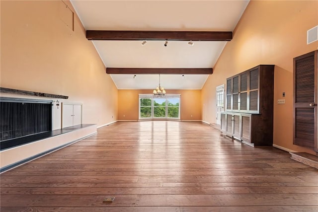 378 Stoneylonesome Rd, Cook Twp, PA 15687 - unfurnished living room featuring a chandelier, beamed ceiling, wood-type flooring, high vaulted ceiling, and baseboards