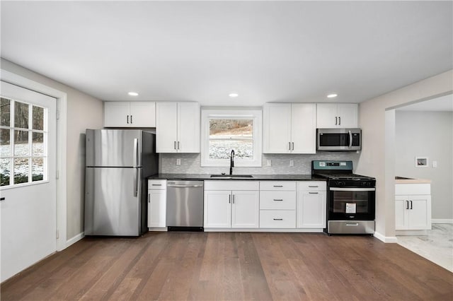 155 Old E Butler Rd, Summit Twp But, PA 16002 - kitchen featuring stainless steel appliances, a sink, dark wood-style floors, decorative backsplash, and recessed lighting