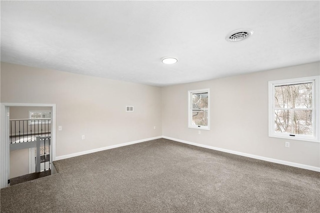 155 Old E Butler Rd, Summit Twp But, PA 16002 - unfurnished room with healthy amount of natural light, dark colored carpet, and baseboards