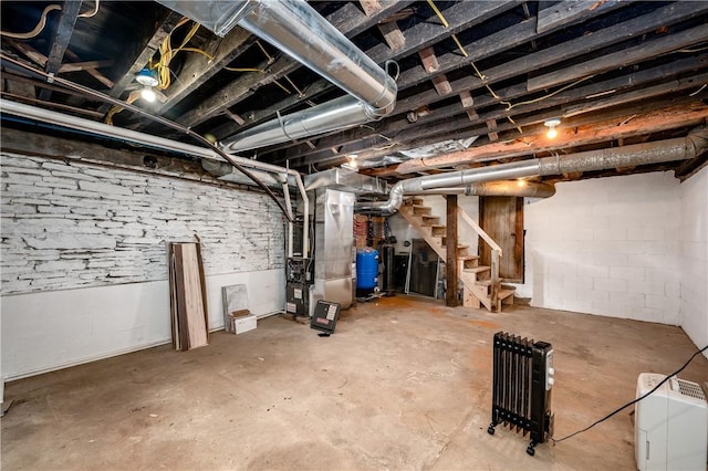 155 Old E Butler Rd, Summit Twp But, PA 16002 - unfinished below grade area featuring heating unit, stairs, and a water pressure tank